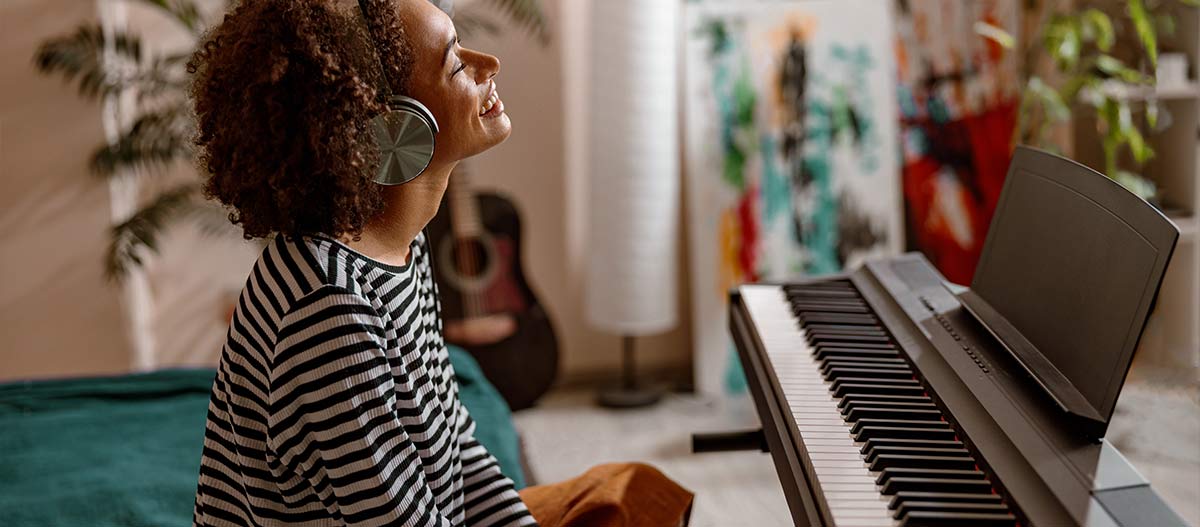 Woman listening to music with piano in front