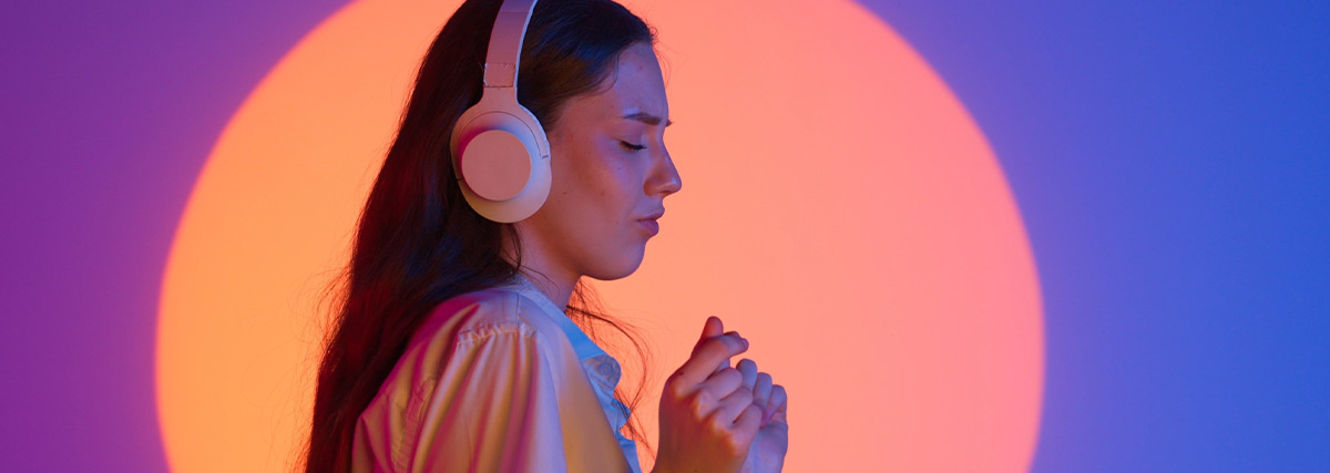 Woman listening to music with spot light background