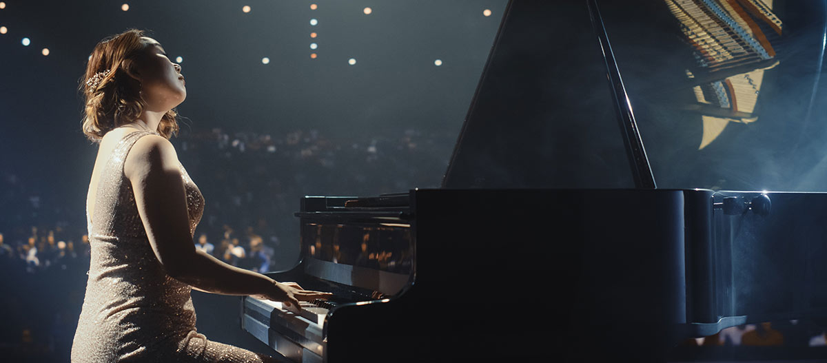 Woman pianist performing emotionally on stage