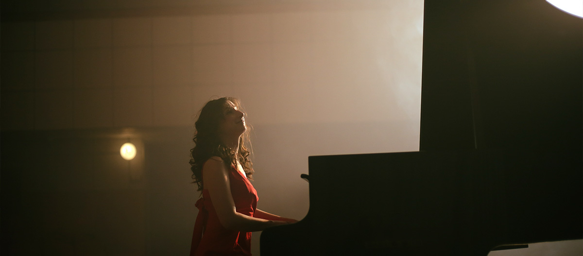 Woman playing grand piano