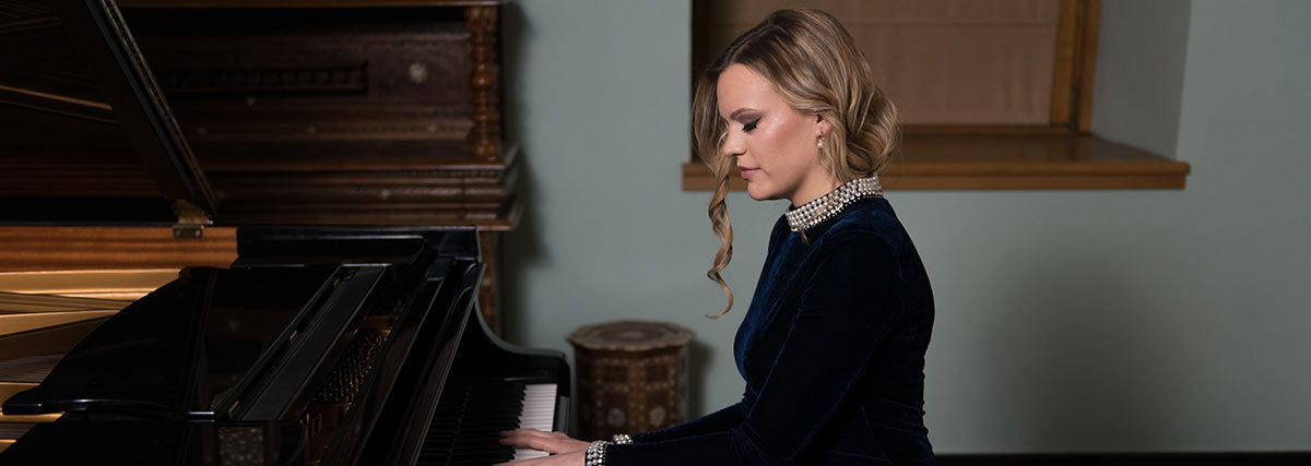 woman playing the grand piano