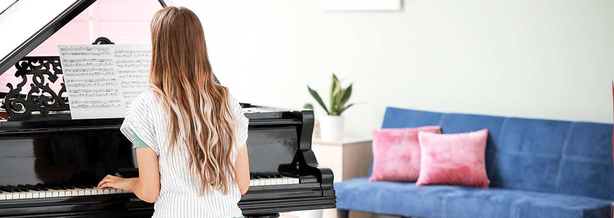 woman playing the piano at home
