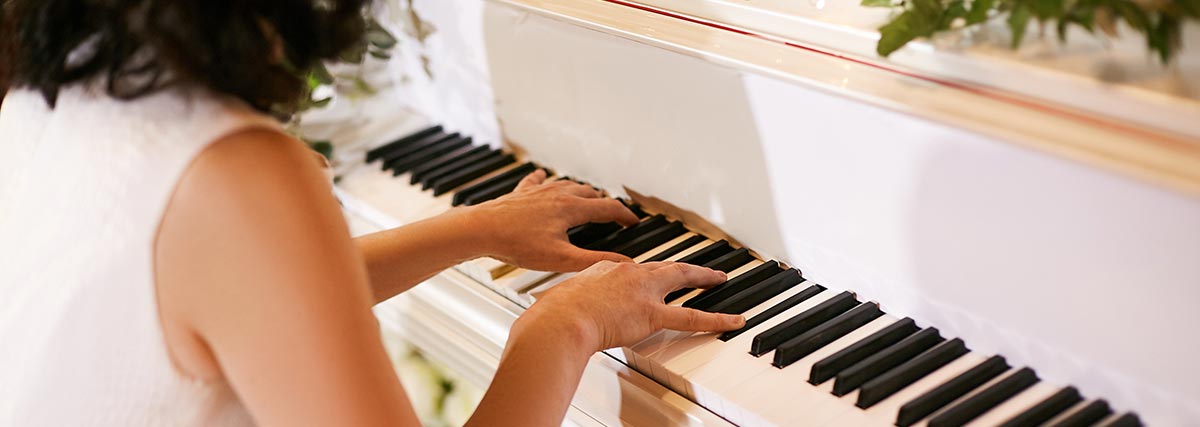 woman practising on white piano