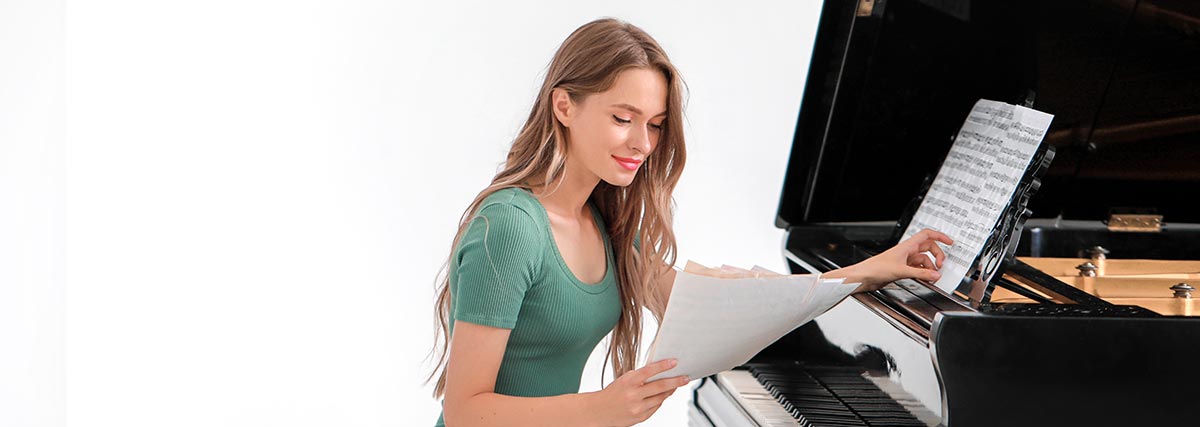 woman reading music on the piano